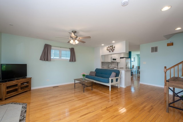 22869 W Lake Shore Dr, Antioch, IL 60002 - living room featuring light wood-style flooring, ceiling fan, stairs, and recessed lighting