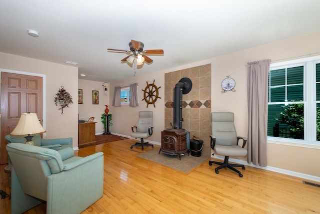 22869 W Lake Shore Dr, Antioch, IL 60002 - living room with a wood stove, ceiling fan, wood finished floors, and plenty of natural light