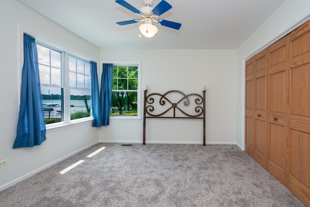 22869 W Lake Shore Dr, Antioch, IL 60002 - unfurnished bedroom featuring carpet flooring, a closet, and a ceiling fan