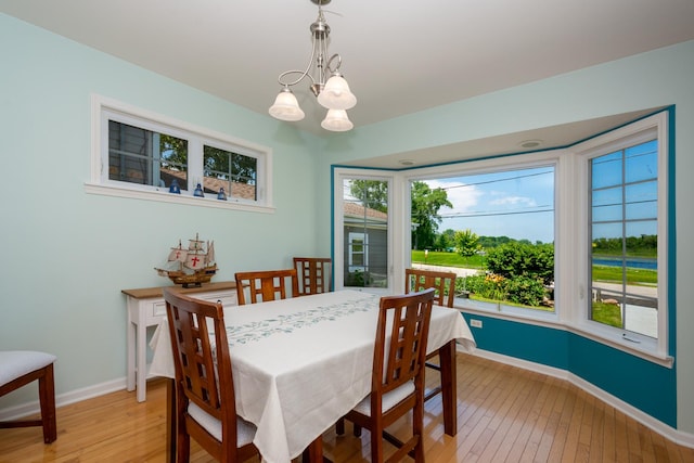 22869 W Lake Shore Dr, Antioch, IL 60002 - dining area with light wood-style flooring and a chandelier