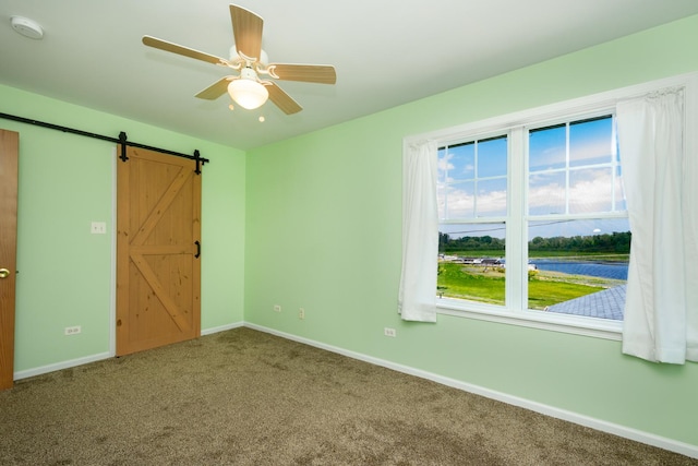 22869 W Lake Shore Dr, Antioch, IL 60002 - unfurnished bedroom with carpet, a barn door, a water view, and ceiling fan