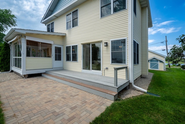 22869 W Lake Shore Dr, Antioch, IL 60002 - back of property with a sunroom, a lawn, a patio area, and a wooden deck