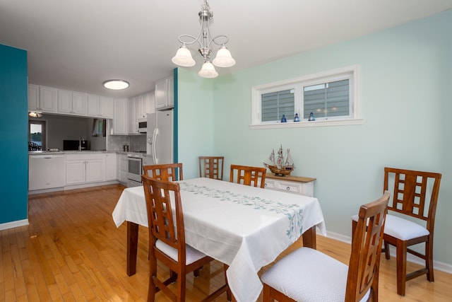 22869 W Lake Shore Dr, Antioch, IL 60002 - dining room featuring light wood finished floors and a chandelier