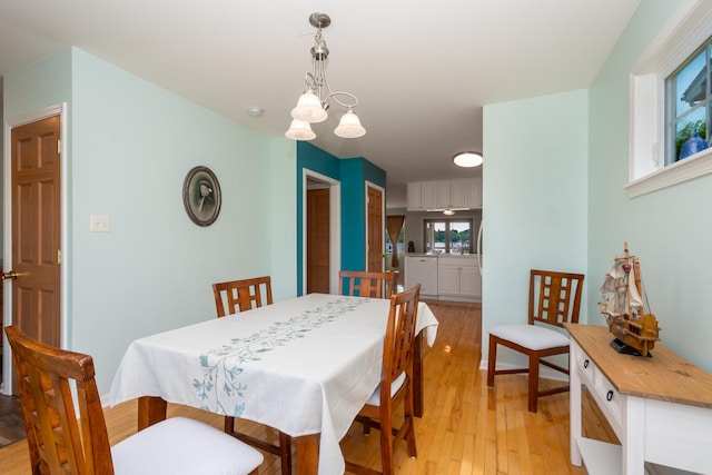 22869 W Lake Shore Dr, Antioch, IL 60002 - dining area with light wood-style floors and a chandelier
