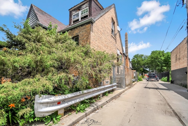 8645 S Bennett Ave, Chicago, IL 60617 - view of property exterior featuring brick siding and driveway