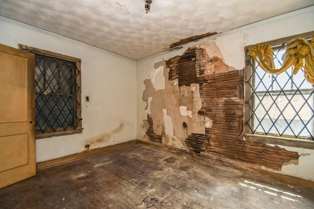 8645 S Bennett Ave, Chicago, IL 60617 - unfurnished living room featuring hardwood / wood-style floors and a textured ceiling