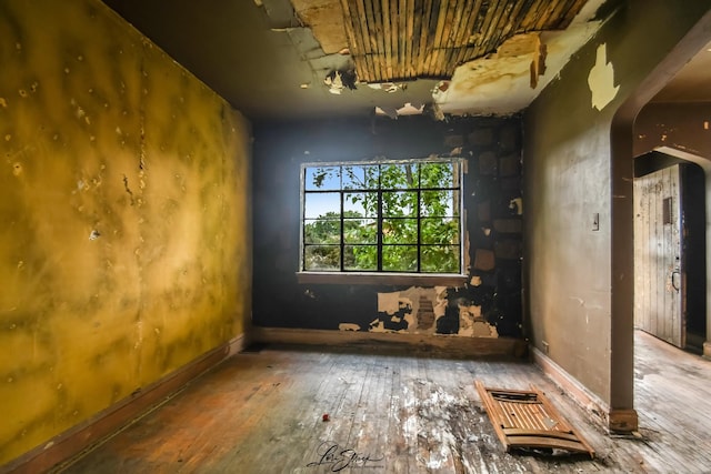 8645 S Bennett Ave, Chicago, IL 60617 - empty room with arched walkways and hardwood / wood-style floors