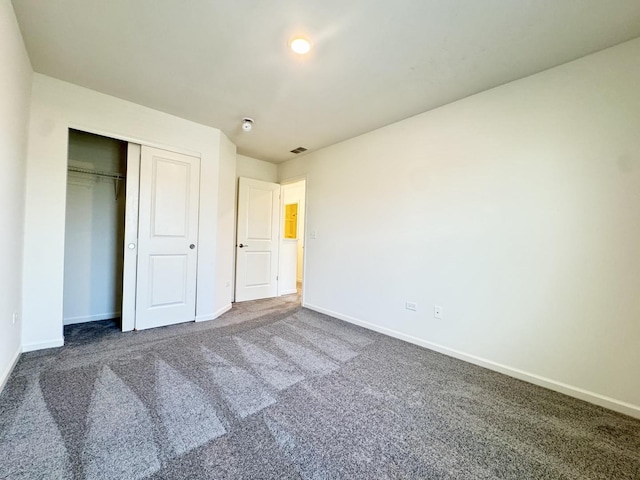 15041 W Quincy Cir, Manhattan, IL 60442 - unfurnished bedroom featuring dark carpet and a closet