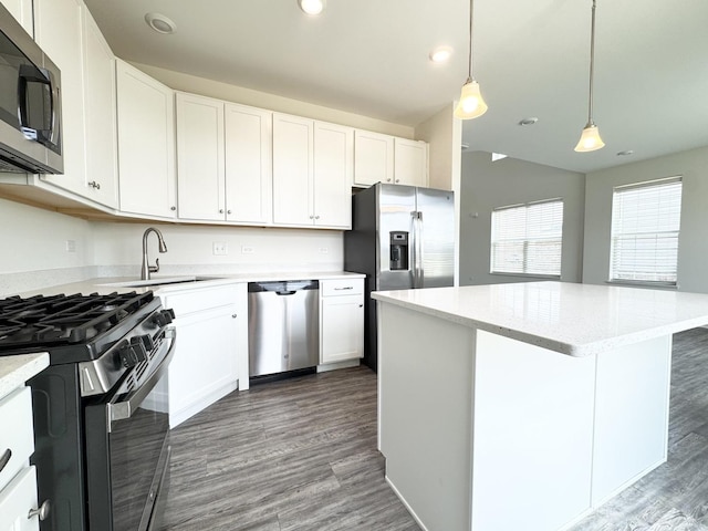 15041 W Quincy Cir, Manhattan, IL 60442 - kitchen featuring appliances with stainless steel finishes, wood finished floors, a center island, white cabinetry, and recessed lighting