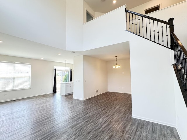 15041 W Quincy Cir, Manhattan, IL 60442 - unfurnished living room featuring dark wood finished floors, stairs, a chandelier, recessed lighting, and a towering ceiling