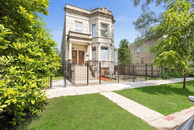 1643 S Millard Ave, Chicago, IL 60623 - italianate house with stone siding, a fenced front yard, and a gate
