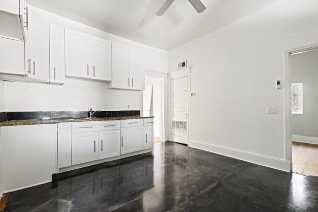 1643 S Millard Ave, Chicago, IL 60623 - kitchen with white cabinets, a ceiling fan, and dark stone countertops