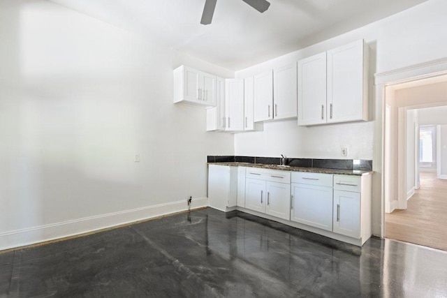 1643 S Millard Ave, Chicago, IL 60623 - kitchen with ceiling fan, white cabinets, and dark stone counters