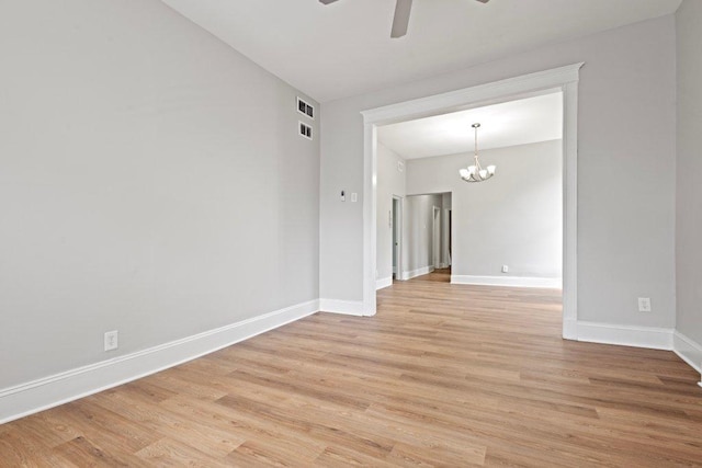1643 S Millard Ave, Chicago, IL 60623 - spare room featuring ceiling fan, light wood-type flooring, and a chandelier