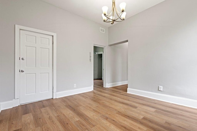 1643 S Millard Ave, Chicago, IL 60623 - spare room featuring a chandelier and light wood-style flooring
