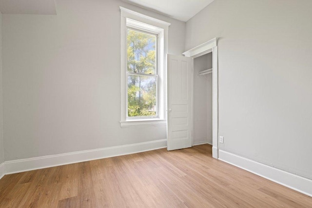 1643 S Millard Ave, Chicago, IL 60623 - unfurnished bedroom featuring light wood-style floors and multiple windows