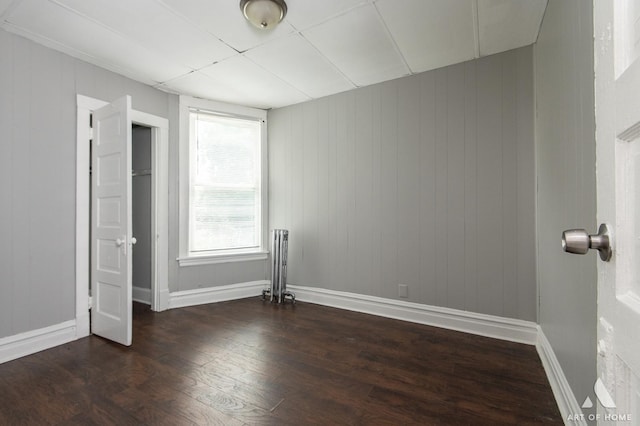 1229 E 71st St, Chicago, IL 60619 - unfurnished bedroom with wood finished floors and baseboards