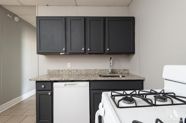 1229 E 71st St, Chicago, IL 60619 - kitchen with white appliances, gray cabinetry, light stone countertops, and light tile patterned floors