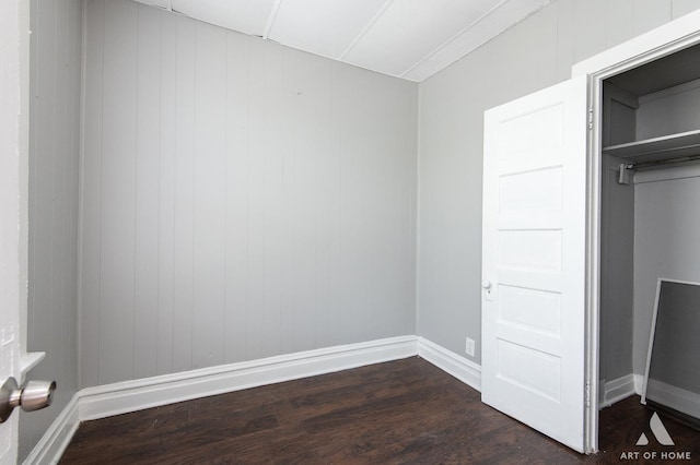 1229 E 71st St, Chicago, IL 60619 - unfurnished bedroom with dark wood-style floors and baseboards