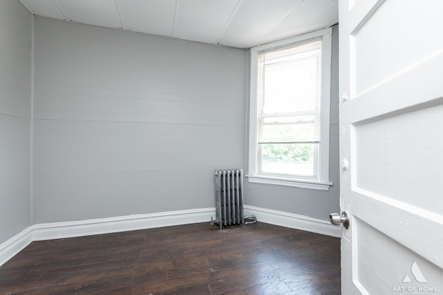1229 E 71st St, Chicago, IL 60619 - spare room with radiator heating unit and dark wood-style flooring