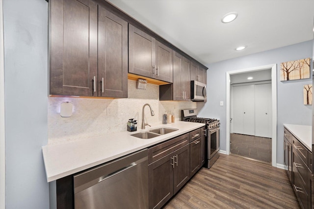 1033 W Indiana St, Glenwood, IL 60425 - kitchen with appliances with stainless steel finishes, dark brown cabinets, dark wood-style floors, light countertops, and recessed lighting