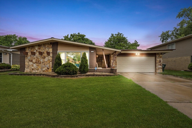 1033 W Indiana St, Glenwood, IL 60425 - mid-century modern home with stone siding, concrete driveway, an attached garage, a front yard, and brick siding