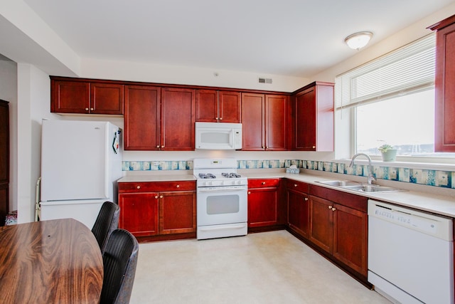 8300 Callie Ave Unit 314, Morton Grove, IL 60053 - kitchen with white appliances, reddish brown cabinets, and light countertops
