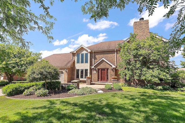 21978 Princeton Cir, Frankfort, IL 60423 - view of front facade featuring a front yard, brick siding, a chimney, and a shingled roof