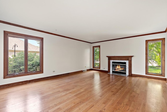 21978 Princeton Cir, Frankfort, IL 60423 - unfurnished living room with healthy amount of natural light, light wood-style floors, a premium fireplace, and crown molding