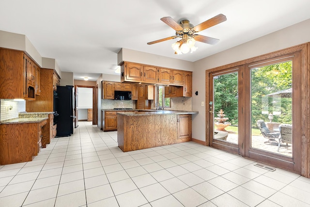 21978 Princeton Cir, Frankfort, IL 60423 - kitchen featuring a peninsula, decorative backsplash, brown cabinets, and black appliances
