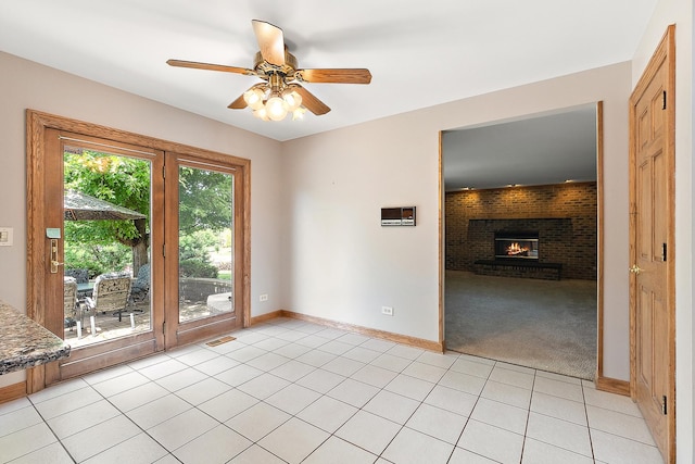 21978 Princeton Cir, Frankfort, IL 60423 - spare room with ceiling fan, a fireplace, light tile patterned floors, and light colored carpet