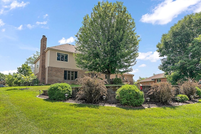 21978 Princeton Cir, Frankfort, IL 60423 - view of side of property featuring a chimney, a yard, and brick siding