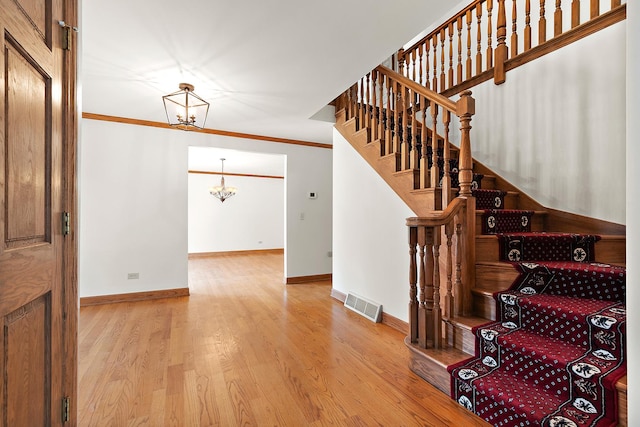 21978 Princeton Cir, Frankfort, IL 60423 - stairs with a chandelier, wood finished floors, and ornamental molding