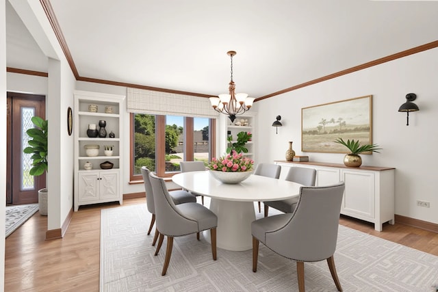21978 Princeton Cir, Frankfort, IL 60423 - dining area featuring a chandelier, plenty of natural light, light wood finished floors, and ornamental molding