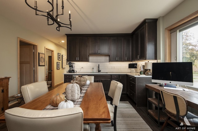 6928 Pershing Rd, Berwyn, IL 60402 - kitchen featuring backsplash, a chandelier, wood finished floors, dark brown cabinets, and light countertops