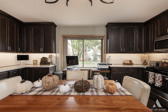 6928 Pershing Rd, Berwyn, IL 60402 - kitchen with range with gas cooktop, stainless steel microwave, backsplash, and light countertops