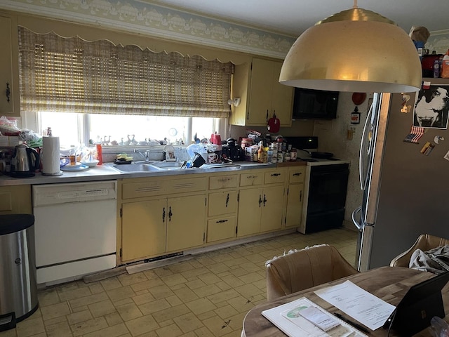 3900 Clausen Ave, Western Springs, IL 60558 - kitchen with dishwasher, freestanding refrigerator, range with electric stovetop, and cream cabinetry