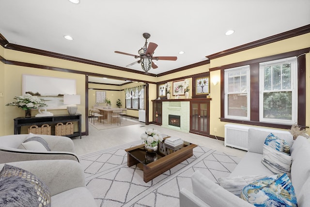 5019 N Kostner Ave, Chicago, IL 60630 - living area featuring crown molding, wood finished floors, recessed lighting, ceiling fan, and a warm lit fireplace
