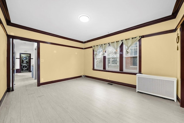 5019 N Kostner Ave, Chicago, IL 60630 - unfurnished room featuring radiator heating unit, light wood-style floors, and ornamental molding