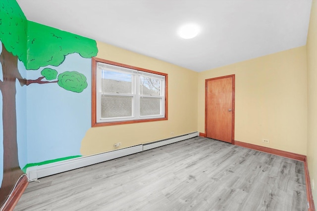 5019 N Kostner Ave, Chicago, IL 60630 - spare room featuring a baseboard heating unit and light wood-type flooring