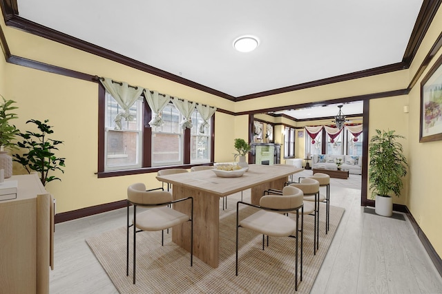 5019 N Kostner Ave, Chicago, IL 60630 - dining room featuring ornamental molding, a chandelier, and light wood-style flooring