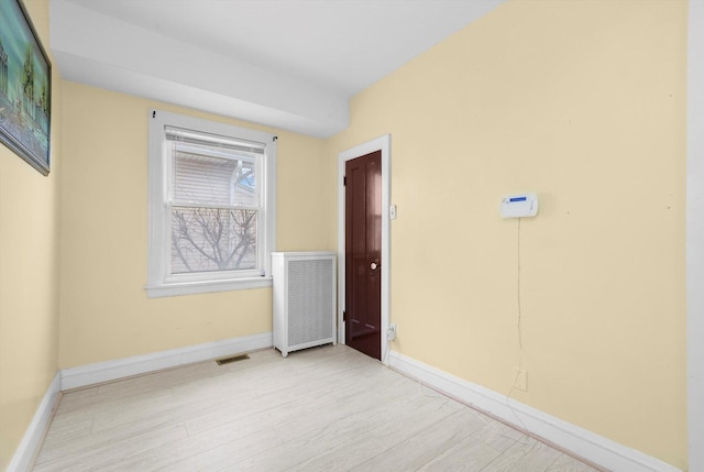 5019 N Kostner Ave, Chicago, IL 60630 - unfurnished room featuring radiator heating unit and wood finished floors