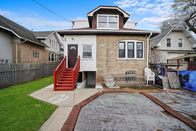 5019 N Kostner Ave, Chicago, IL 60630 - back of house with a fenced backyard, brick siding, entry steps, and a patio