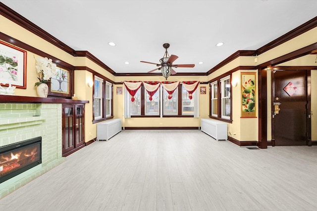 5019 N Kostner Ave, Chicago, IL 60630 - unfurnished living room with crown molding, a ceiling fan, wood finished floors, a fireplace, and radiator heating unit