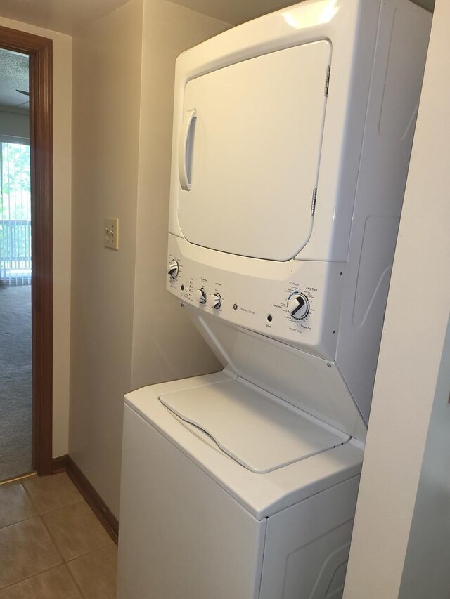 505 Redondo Dr Unit 108, Downers Grove, IL 60515 - laundry room with estacked washer and dryer and light tile patterned flooring