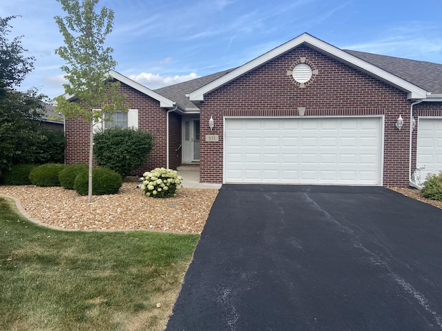 831 Oriole Dr, Peotone, IL 60468 - single story home featuring brick siding, a garage, asphalt driveway, and a shingled roof