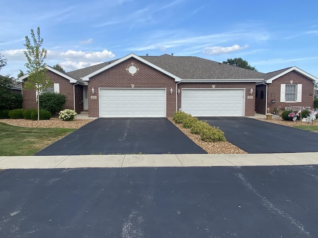 831 Oriole Dr, Peotone, IL 60468 - ranch-style home featuring asphalt driveway, a garage, and brick siding