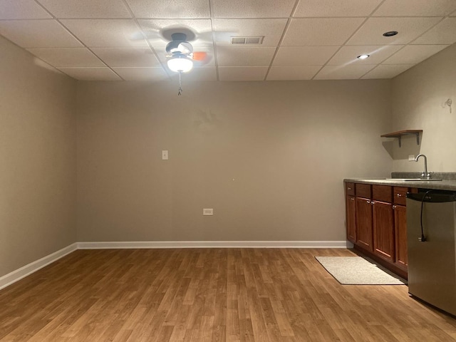 831 Oriole Dr, Peotone, IL 60468 - kitchen with a paneled ceiling, light wood-style flooring, open shelves, and light countertops