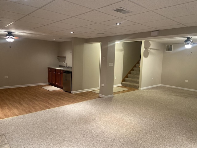 831 Oriole Dr, Peotone, IL 60468 - finished below grade area with a paneled ceiling, carpet floors, bar with sink, stairs, and a ceiling fan