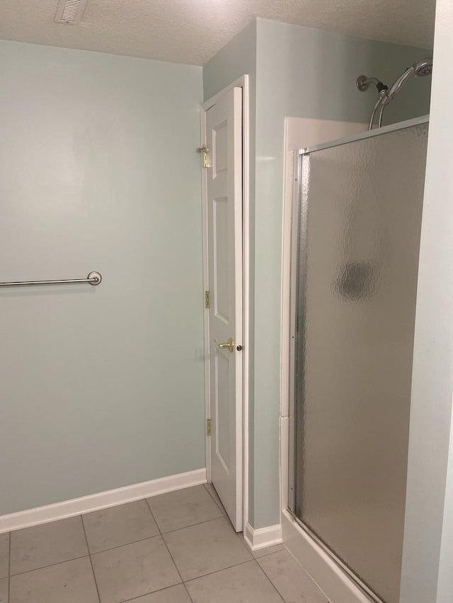 831 Oriole Dr, Peotone, IL 60468 - bathroom featuring a stall shower and tile patterned flooring